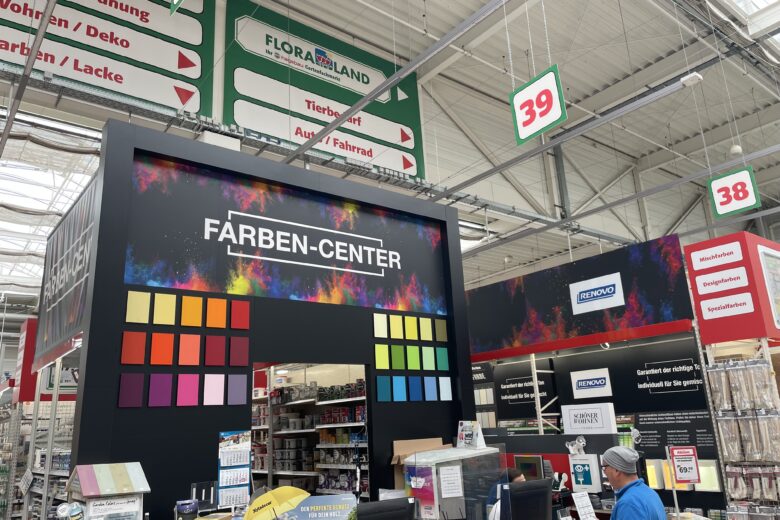 Farben-Center mit bunten Farbmusterkarten in einem Baumarkt.